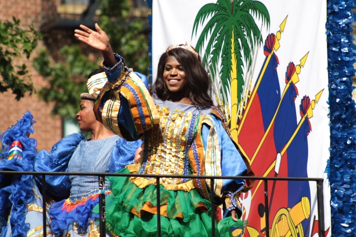 A young woman dressed in traditional Caribbean apparel waves to the crowd. The West Indian Day Parade means summertime in Brooklyn is almost over. 