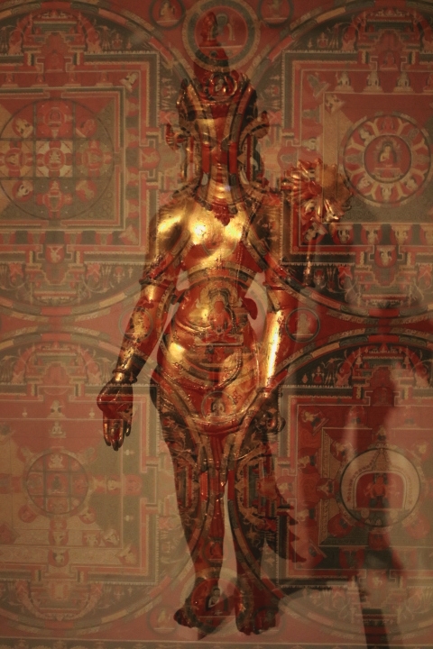 A double exposure of bronze statue of a deity and mandalas at the Rubin Museum.