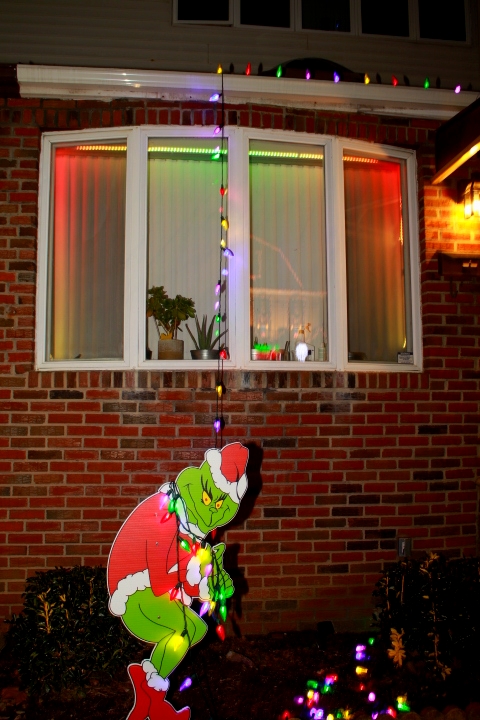 A clever decoration shows the Grinch pulling down lights like he does in the movie.