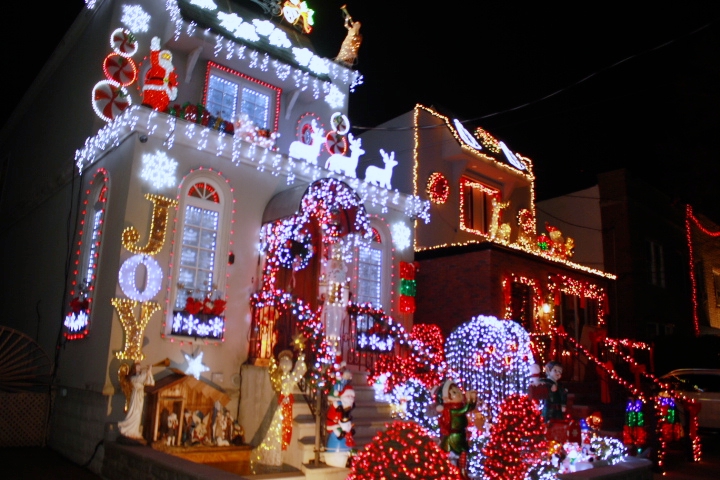 A silvery lit house next to a golden lit one in Brooklyn's wonderland.