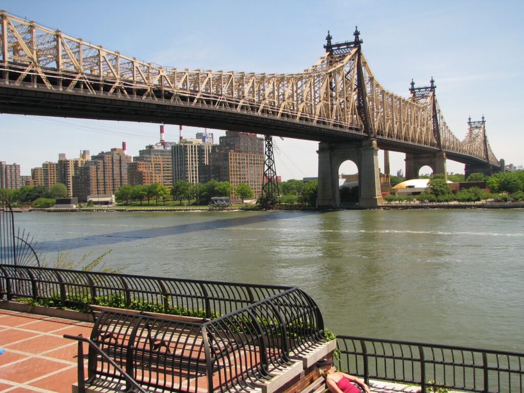Ed Koch Bridge on a sunny day. This bridge is the target of a recent campaign by the Mamdani Administration to scrub Ed Koch's name from it. Bridging the gap between Koch's failures and ideals is the only wise approach for New York City.